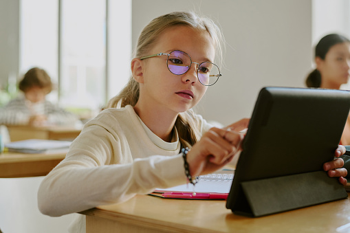 Girl Using Tablet Device in Classroom Setting